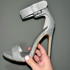 Never worn. Silver glitter 5” stiletto heels, size 5